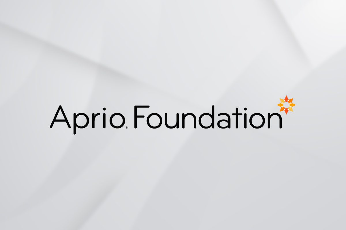 The image shows the text “Aprio Foundation” in black letters on a light gray background, with an orange geometric star icon above the letter i in Foundation.