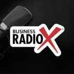 A microphone sits next to the Business RadioX logo on a black background.