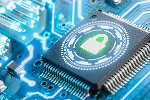 Close-up of a computer microchip on a circuit board, featuring a glowing green padlock icon symbolizing cybersecurity or data protection.