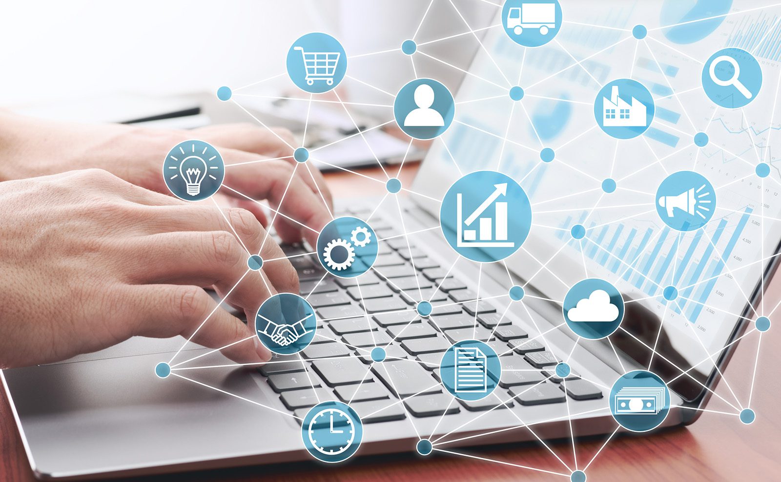 Hands typing on a laptop keyboard with various business and technology icons connected in a network overlay, representing digital business solutions.