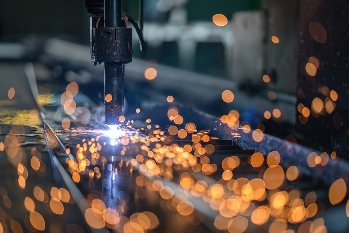 Computer Numerical Control for cutting and weld steel structure at industrial manufacturer. Engineer oder work to CNC machine for build steel frame at steel factory.