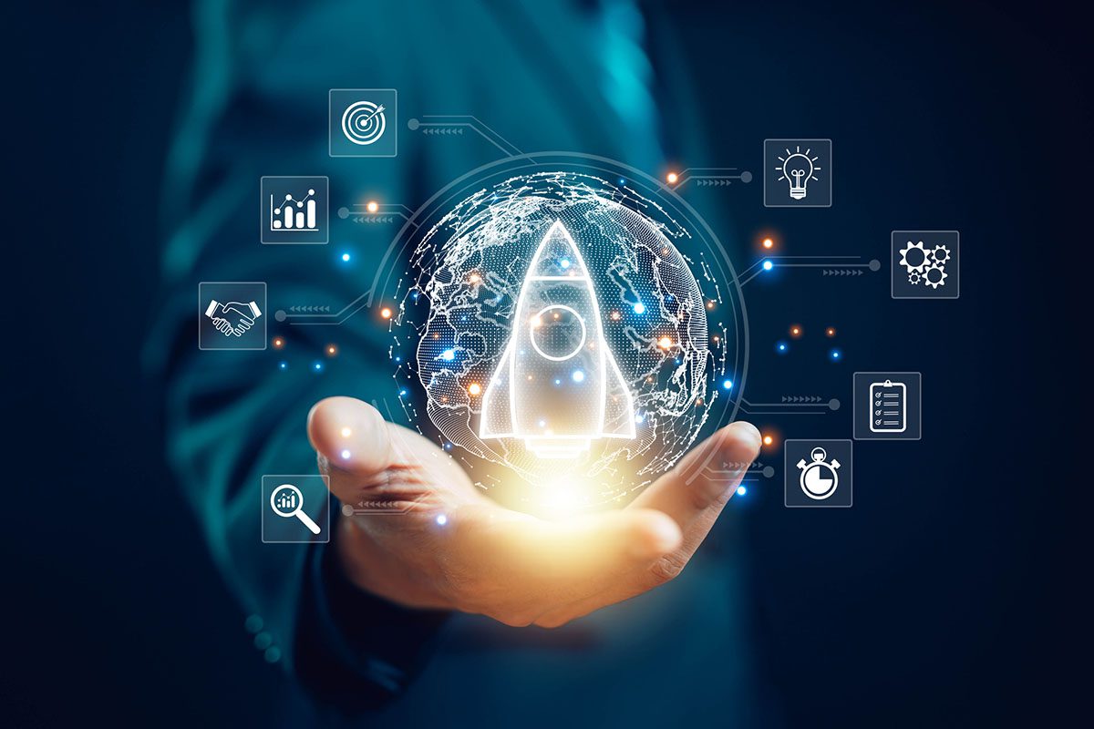 A person holds a glowing digital globe with a rocket icon at the center, surrounded by icons representing business, technology, and innovation concepts.