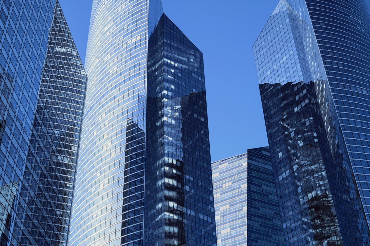 Close-up of modern office facades at business district at a clear sunny day