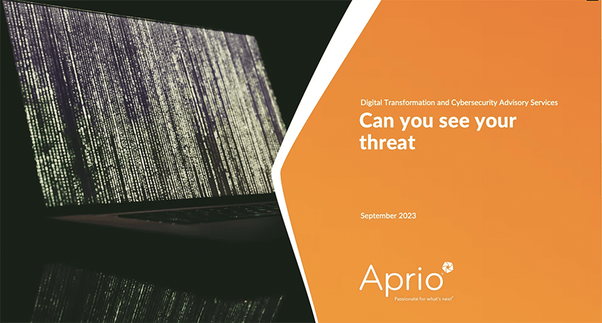 A laptop with a screen of vertical digital code sits beside an orange slide titled Can you see your threat by Aprio, about cybersecurity, dated September 2023.